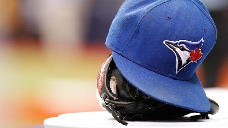 Jul 12, 2014; St. Petersburg, FL, USA; Toronto Blue Jays hat and glove lay in the dugout against the Tampa Bay Rays at Tropicana Field. Mandatory Credit: Kim Klement-USA TODAY Sports