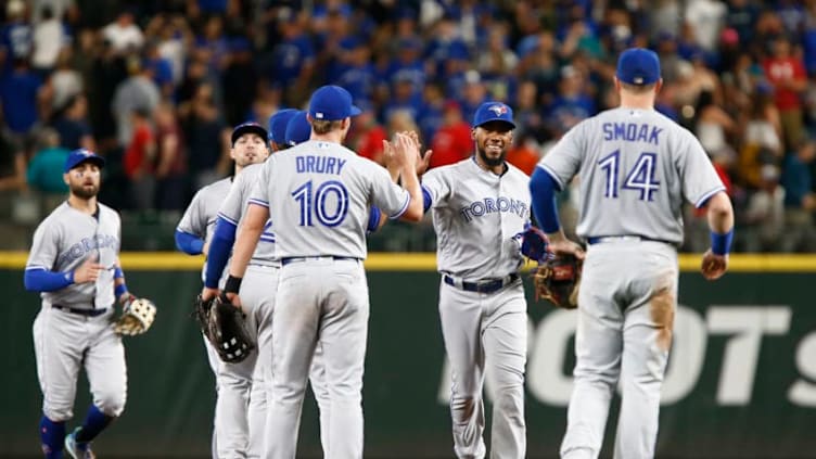 SEATTLE, WA - AUGUST 04: Teoscar Hernandez #37 of the Toronto Blue Jays, center, high-fives with Brandon Drury #10 after their win over the Seattle Mariners at Safeco Field on August 4, 2018 in Seattle, Washington. (Photo by Lindsey Wasson/Getty Images)