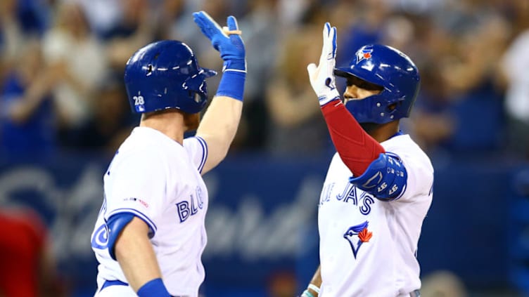 TORONTO, ON - AUGUST 13: Teoscar Hernandez #37 (R) of the Toronto Blue Jays hits a solo home run and celebrates with Billy McKinney #28 in the sixth inning during a MLB game against the Texas Rangers at Rogers Centre on August 13, 2019 in Toronto, Canada. (Photo by Vaughn Ridley/Getty Images)