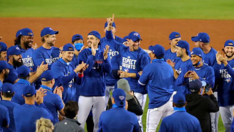 BUFFALO, NY - SEPTEMBER 24: The Toronto Blue Jays celebrate a win against the New York Yankees at Sahlen Field and celebrate a 2020 postseason berth on September 24, 2020 in Buffalo, New York. The Blue Jays are the home team due to the Canadian government's policy on COVID-19, which prevents them from playing in their home stadium in Canada. Blue Jays beat the Yankees 4 to 1. (Photo by Timothy T Ludwig/Getty Images)