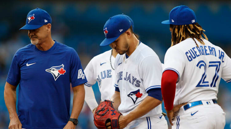 TORONTO, ON - AUGUST 24: Jose Berrios #17 of the Toronto Blue Jays stands in the middle of a meeting on the mound in the first inning of their MLB game against the Chicago White Sox at Rogers Centre on August 24, 2021 in Toronto, Ontario. (Photo by Cole Burston/Getty Images)