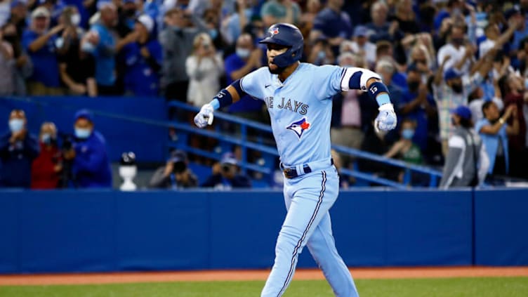 TORONTO, ON - SEPTEMBER 03: Lourdes Gurriel Jr. #13 of the Toronto Blue Jays celebrates after hitting a game-tying grand slam home run in the eighth inning during an MLB game against the Oakland Athletics at Rogers Centre on September 3, 2021 in Toronto, Ontario, Canada. (Photo by Vaughn Ridley/Getty Images)