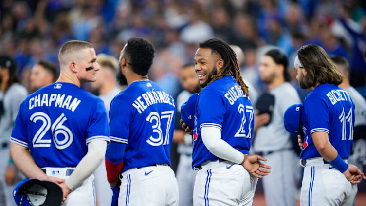 TORONTO, ON - OCTOBER 07: Vladimir Guerrero Jr. #27, Teoscar Hernandez #37, Bo Bichette #11, and Matt Chapman #26 of the Toronto Blue Jays stand during the national anthems before playing the Seattle Mariners during in Game One of their AL Wild Card series at Rogers Centre on October 7, 2022 in Toronto, Ontario, Canada. (Photo by Mark Blinch/Getty Images)