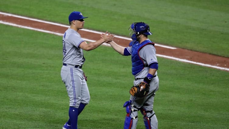 BALTIMORE, MD - AUGUST 31: Pitcher Roberto Osuna #54 and catcher Miguel Montero #47 celebrate the Blue Jays 11-8 win at Oriole Park at Camden Yards on August 31, 2017 in Baltimore, Maryland. (Photo by Rob Carr/Getty Images)