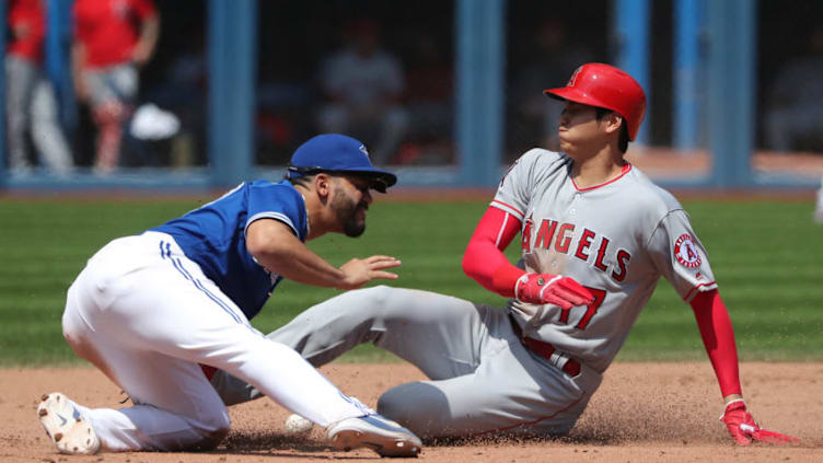 TORONTO, ON - MAY 24: Shohei Ohtani #17 of the Los Angeles Angels of Anaheim arrives safely at second base in the eighth inning during MLB game action as Devon Travis #29 of the Toronto Blue Jays cannot handle the throw at Rogers Centre on May 24, 2018 in Toronto, Canada. (Photo by Tom Szczerbowski/Getty Images)