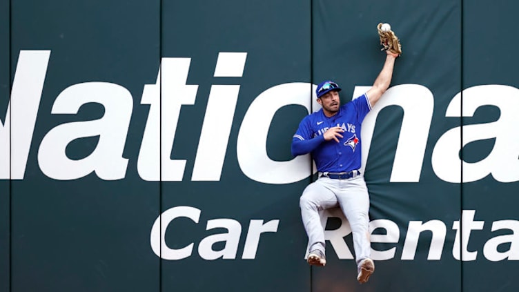 ARLINGTON, TEXAS - APRIL 05: Randal Grichuk #15 of the Toronto Blue Jays drops the ball at the wall on a RBI double hit by Brock Holt #16 of the Texas Rangers in the bottom of the ninth inning on Opening Day at Globe Life Field on April 05, 2021 in Arlington, Texas. (Photo by Tom Pennington/Getty Images)