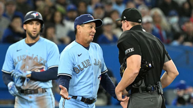 Apr 17, 2022; Toronto, Ontario, CAN; Toronto Blue Jays manager Charlie Montoyo (25) speaks with home plate umpire Shane Livensparger after he called center fielder George Springer (4) out on batter intereference in the second inning at Rogers Centre. Mandatory Credit: Dan Hamilton-USA TODAY Sports