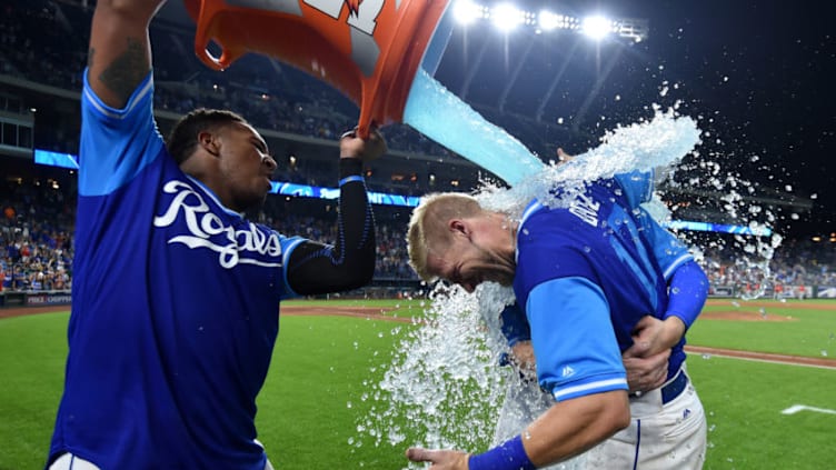 KANSAS CITY, MO - AUGUST 24: Hunter Dozier #17 of the Kansas City Royals and Ryan O'Hearn #66 are doused with Gatorade by Salvador Perez #13 as they celebrate a 5-4 win over the Cleveland Indians at Kauffman Stadium on August 24, 2018 in Kansas City, Missouri. Players are wearing special jerseys with their nicknames on them during Players' Weekend. (Photo by Ed Zurga/Getty Images)