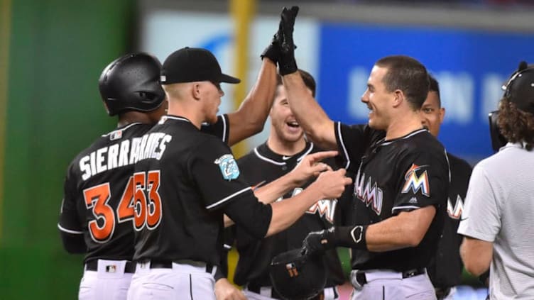 MIAMI, FL - JULY 28: J.T. Realmuto #11 of the Miami Marlins high fives Magneuris Sierra #34 after hitting a walk off single in the tenth inning against the Washington Nationals at Marlins Park on July 28, 2018 in Miami, Florida. (Photo by Eric Espada/Getty Images)