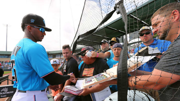 JUPITER, FL - MARCH 10: Lewis Brinson #25 of the Miami Marlins signs autographs before a spring training baseball game against the Washington Nationals at Roger Dean Stadium on March 10, 2020 in Jupiter, Florida. The Marlins defeated the Nationals 3-2. Many teams are considering new policies including players interactions with fans in light of the outbreak of Coronavirus (COVID-19). (Photo by Rich Schultz/Getty Images)