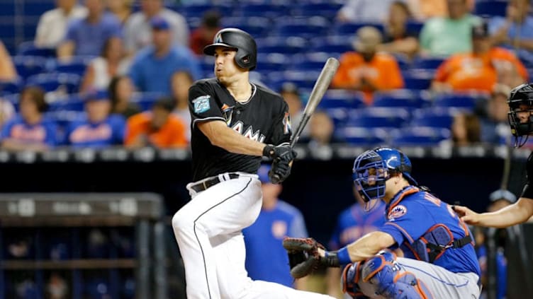 MIAMI, FL - JUNE 29: J.T. Realmuto #11 of the Miami Marlins hits a RBI single in the third inning against the New York Mets at Marlins Park on June 29, 2018 in Miami, Florida. (Photo by Michael Reaves/Getty Images)