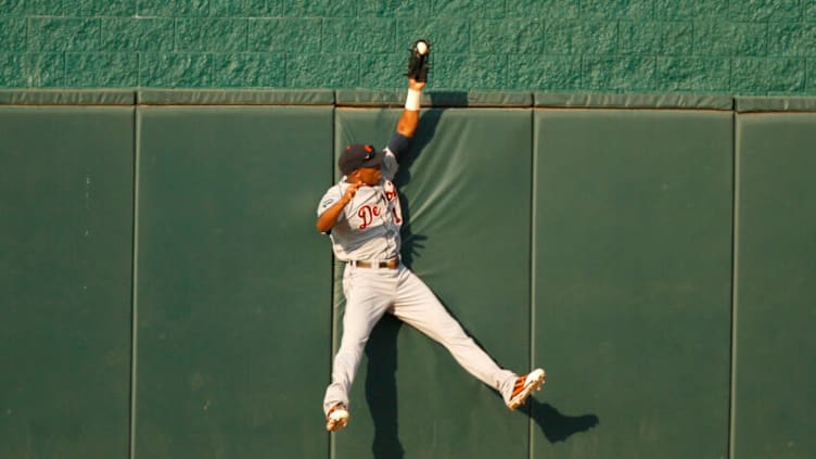 Austin Jackson reaches over the wall to rob the Royals' Alex Gordon of a home run on August 6, 2011 in Kansas City. (Photo by Ed Zurga/Getty Images)