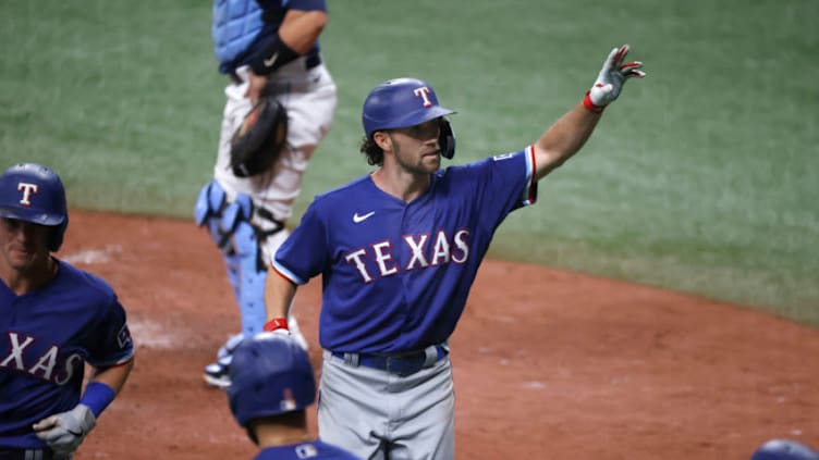 Apr 13, 2021; St. Petersburg, Florida, USA; Texas Rangers shortstop Charlie Culberson (C) celebrates after hitting a two-run home run during the eighth inning against the Tampa Bay Rays at Tropicana Field. Mandatory Credit: Kim Klement-USA TODAY Sports