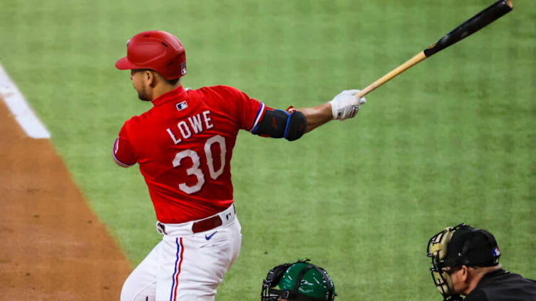 Aug 13, 2021; Arlington, Texas, USA; Texas Rangers first baseman Nathaniel Lowe (30) hits an rbi single during the first inning against the Oakland Athletics at Globe Life Field. Mandatory Credit: Kevin Jairaj-USA TODAY Sports