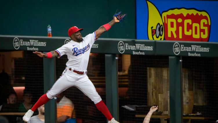 Sep 28, 2021; Arlington, Texas, USA; Texas Rangers right fielder Adolis Garcia (53) catches a foul ball hit by Los Angeles Angels second baseman David Fletcher (not pictured) during the second inning at Globe Life Field. Mandatory Credit: Jerome Miron-USA TODAY Sports