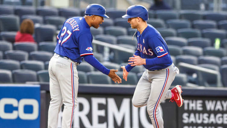 May 8, 2022; Bronx, New York, USA; Texas Rangers second baseman Brad Miller (13) slaps hands with third base coach Tony Beasley (27) after hitting a two run home run during the seventh inning against the New York Yankees at Yankee Stadium. Mandatory Credit: Vincent Carchietta-USA TODAY Sports