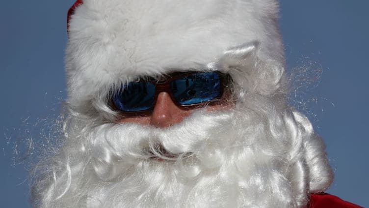 FORT LAUDERDALE, FL - DECEMBER 20: Brent Brean dressed as Santa Claus walks along the beach passing out candy canes and posing for pictures with beach goers on December 20, 2017 in Fort Lauderdale, Florida. Santa Claus has been visiting the Fort Lauderdale beach just before Christmas to spread holiday cheer for over 30 years. (Photo by Joe Raedle/Getty Images)