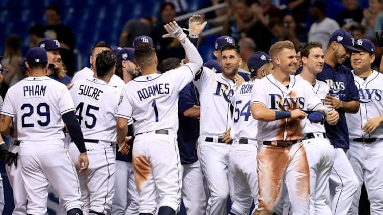 ST PETERSBURG, FL - AUGUST 23: Kevin Kiermaier #39 of the Tampa Bay Rays is congratluated after hitting into a walk off force attempt throwing error by Ryan O'Hearn #66 of the Kansas City Royals in the ninth inning during a game at Tropicana Field on August 23, 2018 in St Petersburg, Florida. (Photo by Mike Ehrmann/Getty Images)