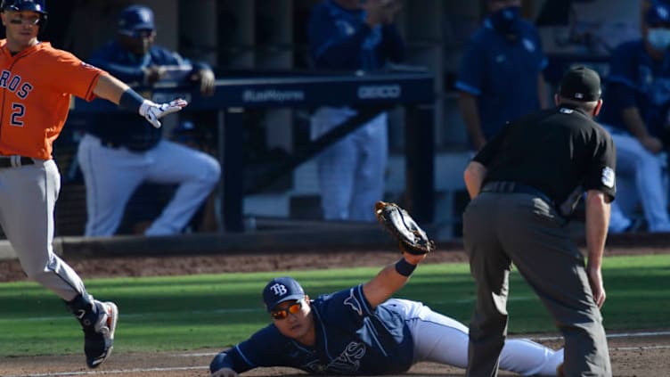 Houston Astros third baseman Alex Bregman is out at first by Tampa Bay Rays first baseman Ji-Man Choi (26) during the eighth inning in game two of the 2020 ALCS at Petco Park. Mandatory Credit: Robert Hanashiro-USA TODAY Sports