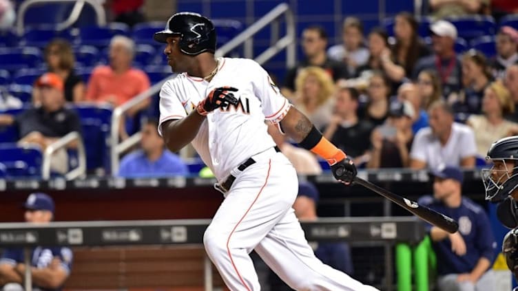 Aug 26, 2016; Miami, FL, USA; Miami Marlins center fielder Marcell Ozuna (13) connects for an RBI double during the first inning against the San Diego Padres at Marlins Park. Mandatory Credit: Steve Mitchell-USA TODAY Sports