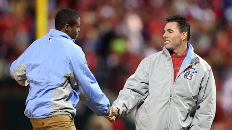 ST LOUIS, MO - OCTOBER 28: Eric Davis Jr (L) and former Cardinal Jim Edmonds deliver the game ball prior to Game Five of the 2013 World Series between the St. Louis Cardinals and the Boston Red Sox at Busch Stadium on October 28, 2013 in St Louis, Missouri. (Photo by Rob Carr/Getty Images)