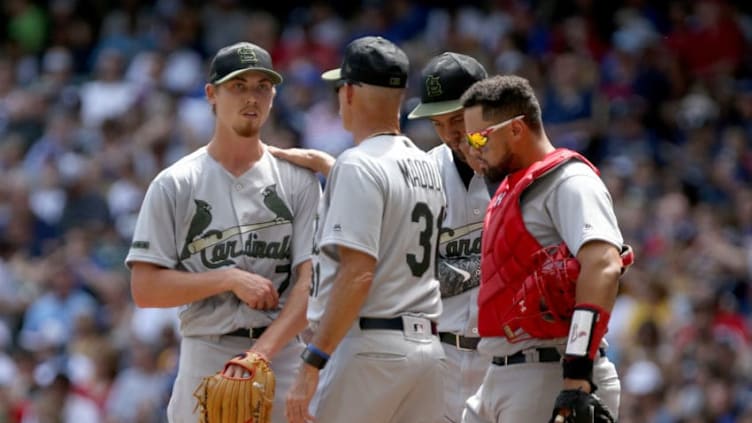 MILWAUKEE, WI - MAY 28: Pitching coach Mike Maddux meets with Luke Weaver #7 of the St. Louis Cardinals in the third inning against the Milwaukee Brewers at Miller Park on May 28, 2018 in Milwaukee, Wisconsin. MLB players across the league are wearing special uniforms to commemorate Memorial Day. (Photo by Dylan Buell/Getty Images)