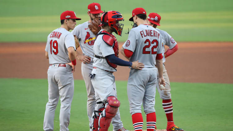 SAN DIEGO, CALIFORNIA - OCTOBER 02: Tommy Edman #19, Paul DeJong #11, Kolten Wong #16 and Yadier Molina #4 talk with Jack Flaherty #22 of the St. Louis Cardinals during the fifth inning of Game Three of the National League Wild Card Series against the San Diego Padres at PETCO Park on October 02, 2020 in San Diego, California. (Photo by Sean M. Haffey/Getty Images)