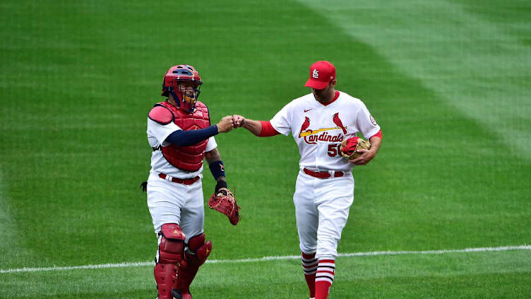 Yadier Molina #4 and Adam Wainwright #50 of the St. Louis Cardinals walk in from the bullpen prior to the home opener against the Milwaukee Brewers at Busch Stadium on April 8, 2021 in St Louis, Missouri. (Photo by Jeff Curry/Getty Images)