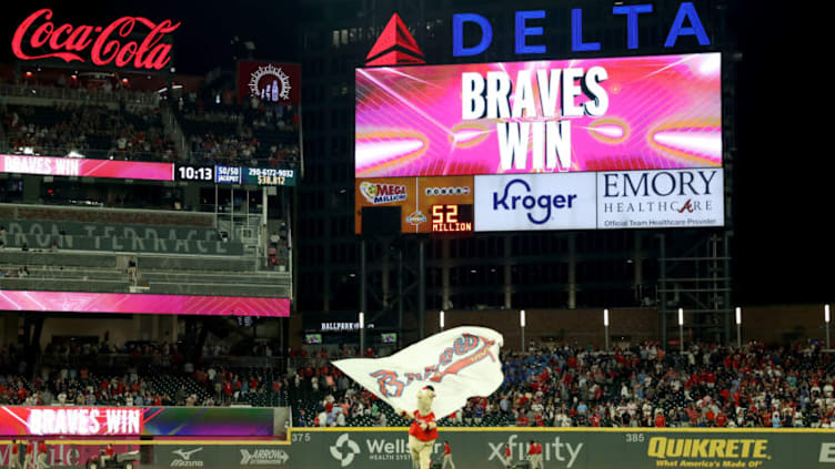 Jun 18, 2021; Atlanta, Georgia, USA; Atlanta Braves mascot Blooper waves a Braves flag after the Atlanta Braves defeated the St. Louis Cardinals at Truist Park. Mandatory Credit: Jason Getz-USA TODAY Sports