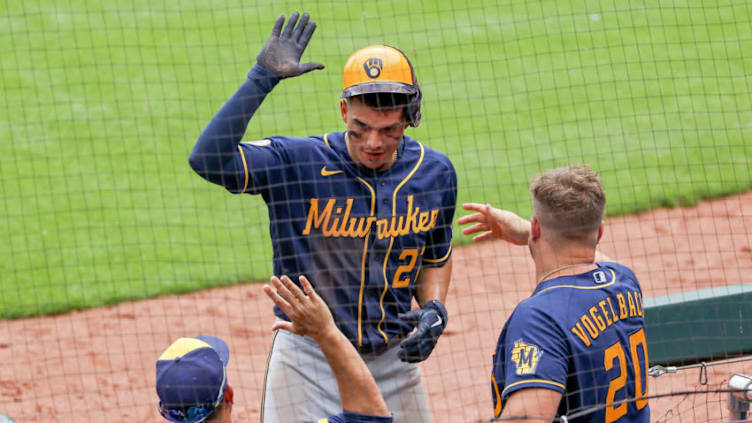 CINCINNATI, OHIO - MAY 23: Willy Adames #27 of the Milwaukee Brewers celebrates with teammates after scoring a run in the sixth inning against the Cincinnati Reds at Great American Ball Park on May 23, 2021 in Cincinnati, Ohio. (Photo by Dylan Buell/Getty Images)