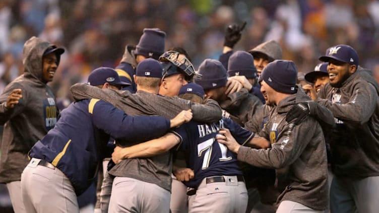 DENVER, CO - OCTOBER 07: Josh Hader #71 of the Milwaukee Brewers is mobbed by teammates after winning Game Three of the National League Division Series over the Colorado Rockies at Coors Field on October 7, 2018 in Denver, Colorado. The Brewers won the game 6-0 and the the series 3-0. (Photo by Matthew Stockman/Getty Images)