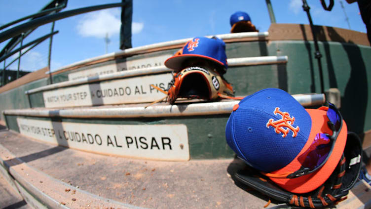 JUPITER, FL - MARCH 12: New Era caps and Wilson gloves of the New York Mets sit on the dugout steps during a spring training baseball game against the Miami Marlins at Roger Dean Stadium on March 12, 2019 in Jupiter, Florida. The Marlins defeated the Mets 8-1. (Photo by Rich Schultz/Getty Images)