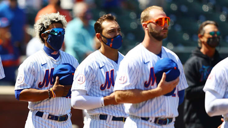 NEW YORK, NEW YORK - APRIL 08: Francisco Lindor #12, Michael Conforto #30 and Pete Alonso #20 of the New York Mets look on during the National Anthem prior to the game against the Miami Marlins at Citi Field on April 08, 2021 in New York City. (Photo by Mike Stobe/Getty Images)