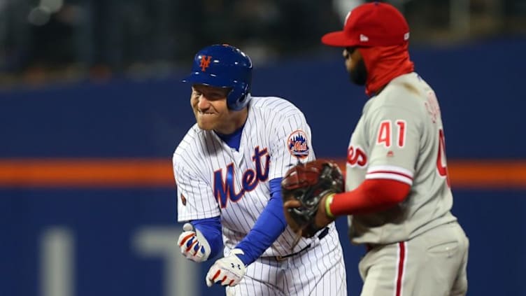 NEW YORK, NY - APRIL 03: Todd Frazier #21 of the New York Mets reacts after hitting an RBI double as Carlos Santana #41 of the Philadelphia Phillies stands by during the sixth inning of a game at Citi Field on April 3, 2018 in the Flushing neighborhood of the Queens borough of New York City. (Photo by Rich Schultz/Getty Images)