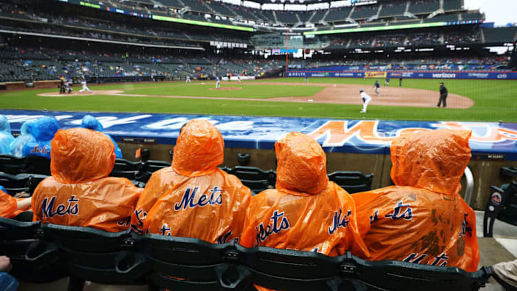 NEW YORK, NY - MAY 16: New York Mets fans sit in the rain watching the New York Mets play against the Toronto Blue Jays during their game at Citi Field on May 16, 2018 in New York City. (Photo by Al Bello/Getty Images)