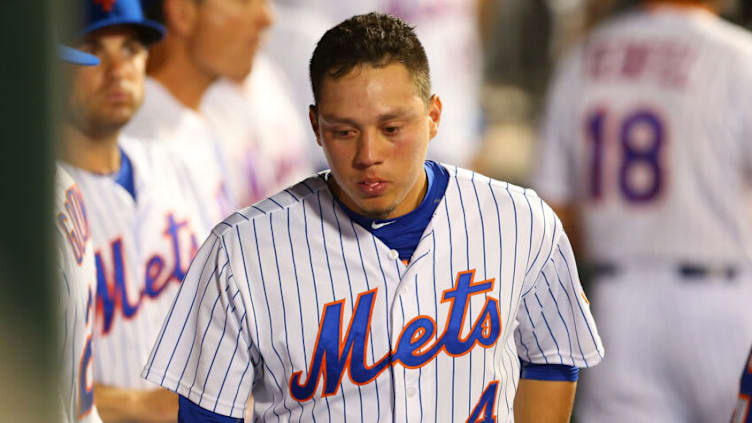 NEW YORK, NY - JULY 29: Wilmer Flores #4 of the New York Mets looks on in the dugout in the ninth inning duirng the game against the San Diego Padres at Citi Field on July 29, 2015 in Flushing neighborhood of the Queens borough of New York City. (Photo by Mike Stobe/Getty Images)