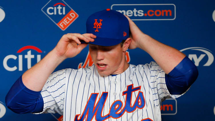 Jun 15, 2019; New York City, NY, USA; New York Mets first round pick in the 2019 MLB draft Brett Baty puts on his uniform after being introduced to the media during a press conference prior to the game between the New York Mets and St. Louis Cardinals at Citi Field. Mandatory Credit: Andy Marlin-USA TODAY Sports