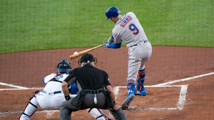 Sep 11, 2020; Buffalo, New York, USA; New York Mets center fielder Brandon Nimmo (9) hits a single during the third inning against the Toronto Blue Jays at Sahlen Field. Mandatory Credit: Gregory Fisher-USA TODAY Sports