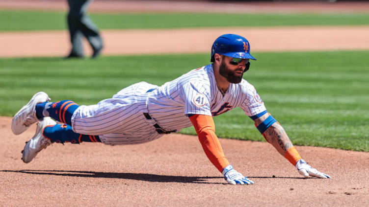 May 12, 2021; New York City, New York, USA; New York Mets center fielder Kevin Pillar (11) slides in to third base for a triple during the second inning against the Baltimore Orioles at Citi Field. Mandatory Credit: Vincent Carchietta-USA TODAY Sports