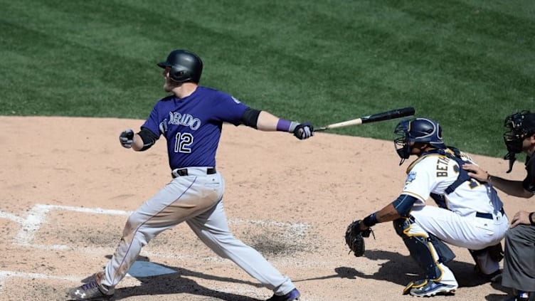 May 4, 2016; San Diego, CA, USA; Colorado Rockies third baseman Mark Reynolds (12) singles during the ninth inning against the San Diego Padres at Petco Park. Mandatory Credit: Jake Roth-USA TODAY Sports