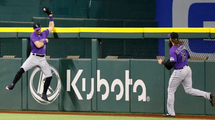 ARLINGTON, TX - APRIL 12: Randal Grichuk #15 of the Colorado Rockies makes a leaping catch above the centerfield wall for a deep ball off the bat of Corey Seager #5 of the Texas Rangers to end the fifth inning at Globe Life Field on April 12, 2022 in Arlington, Texas. (Photo by Ron Jenkins/Getty Images)