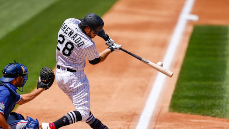 DENVER, CO - AUGUST 16: Nolan Arenado #28 of the Colorado Rockies hits the baseball during the second inning against the Texas Rangers at Coors Field on August 16, 2020 in Denver, Colorado. (Photo by Justin Edmonds/Getty Images)