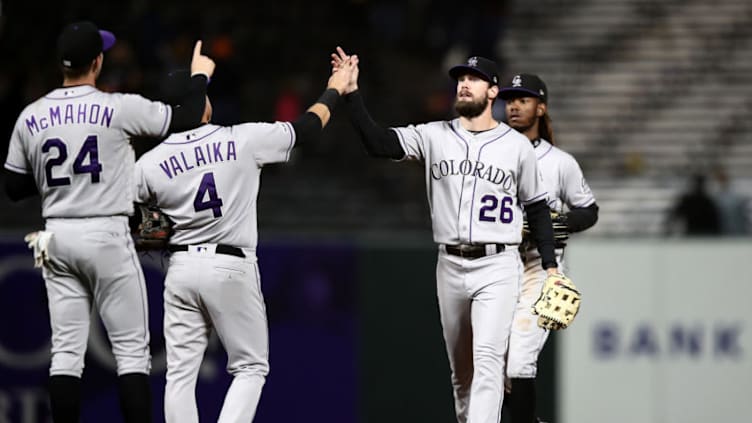 SAN FRANCISCO, CALIFORNIA - JUNE 24: David Dahl #26 of the Colorado Rockies high fives Pat Valaika #4 and Ryan McMahon #24 after they beat the San Francisco Giants at Oracle Park on June 24, 2019 in San Francisco, California. (Photo by Ezra Shaw/Getty Images)