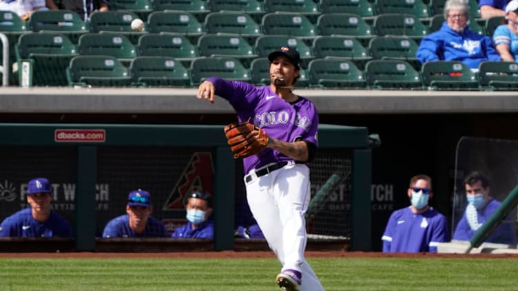 Mar 15, 2021; Salt River Pima-Maricopa, Arizona, USA; Colorado Rockies third baseman Josh Fuentes (8) makes an off balnce throw for an out against the Los Angeles Dodgers during a spring training game at Salt River Fields at Talking Stick. Mandatory Credit: Rick Scuteri-USA TODAY Sports