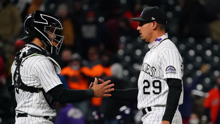 Apr 20, 2021; Denver, Colorado, USA; Colorado Rockies relief pitcher Robert Stephenson (29) and catcher Dom Nunez (3) celebrate defeating the Houston Astros at Coors Field. Mandatory Credit: Ron Chenoy-USA TODAY Sports