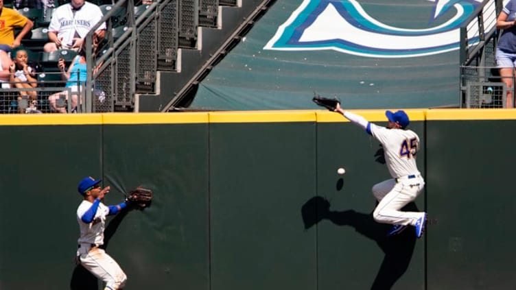 SEATTLE, WA - JULY 28: Kristopher Negron #45 of the Seattle Mariners overruns a double hit by Christin Stewart #14 of the Detroit Tigers as Mallex Smith #0 looks on in the seventh inning at T-Mobile Park on July 28, 2019 in Seattle, Washington. (Photo by Lindsey Wasson/Getty Images)