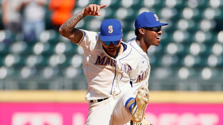 SEATTLE, WASHINGTON - MAY 02: J.P. Crawford #3 and Kyle Lewis #1 of the Seattle Mariners celebrate after defeating the Los Angeles Angels. (Photo by Steph Chambers/Getty Images)