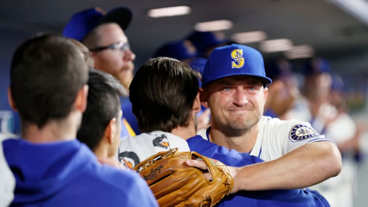 SEATTLE, WASHINGTON - OCTOBER 03: Kyle Seager #15 of the Seattle Mariners hugs teammates as he was pulled from the game during the ninth inning against the Los Angeles Angels at T-Mobile Park on October 03, 2021 in Seattle, Washington. (Photo by Steph Chambers/Getty Images)