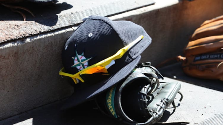 PEORIA, AZ - MARCH 4: A hat and glove of of the Seattle Mariners is seen prior to the game against the San Diego Padreson March 4, 2015 at Peoria Stadium in Peoria, Arizona. The Mariners defeated the Padres 4-3 in 10 innings. (Photo by Rich Pilling/Getty Images)