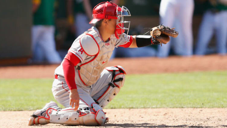 OAKLAND, CALIFORNIA - MAY 30: Catcher Kurt Suzuki #24 of the Los Angeles Angels catches in the game against the Oakland Athletics at RingCentral Coliseum on May 30, 2021 in Oakland, California. (Photo by Lachlan Cunningham/Getty Images)